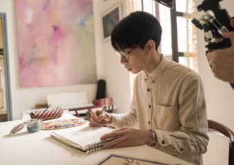Vitorino Vong Writing on a Notepad
